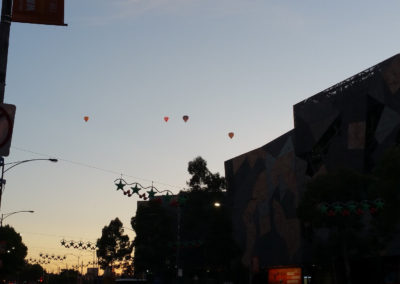 Many hot air balloons above Melbourne city