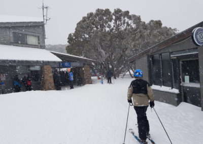 Skiing through village at Mt Buller